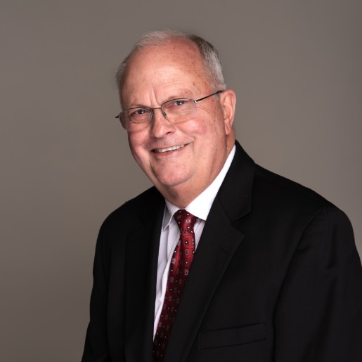 Keith in suit with red tie.