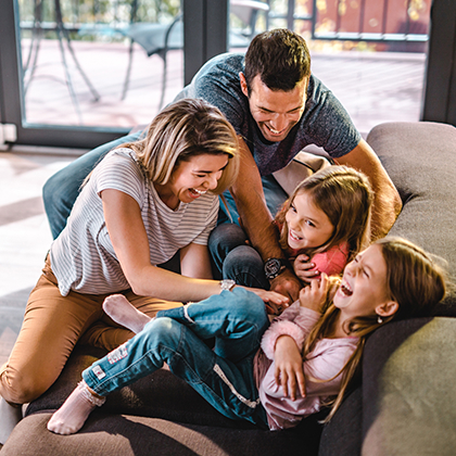 Happy family on their couch.