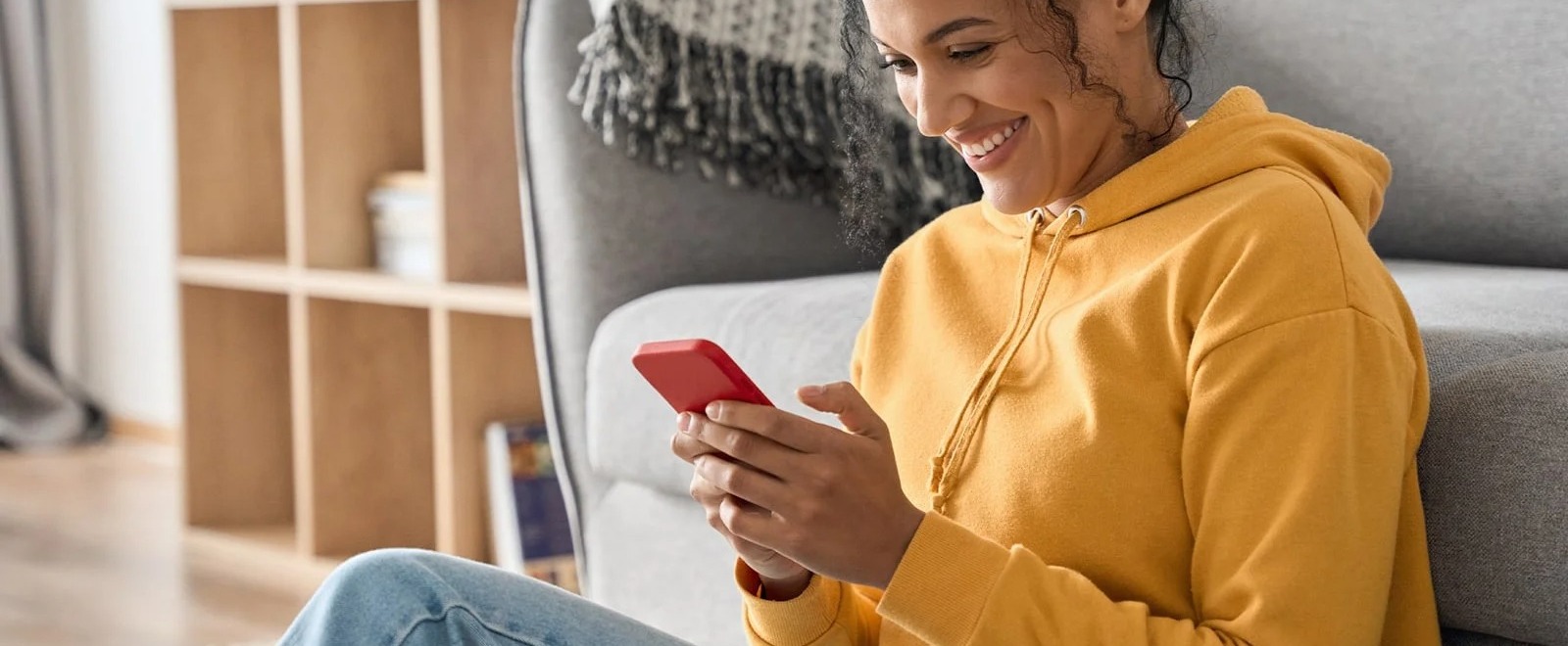 Person smiling using their phone.