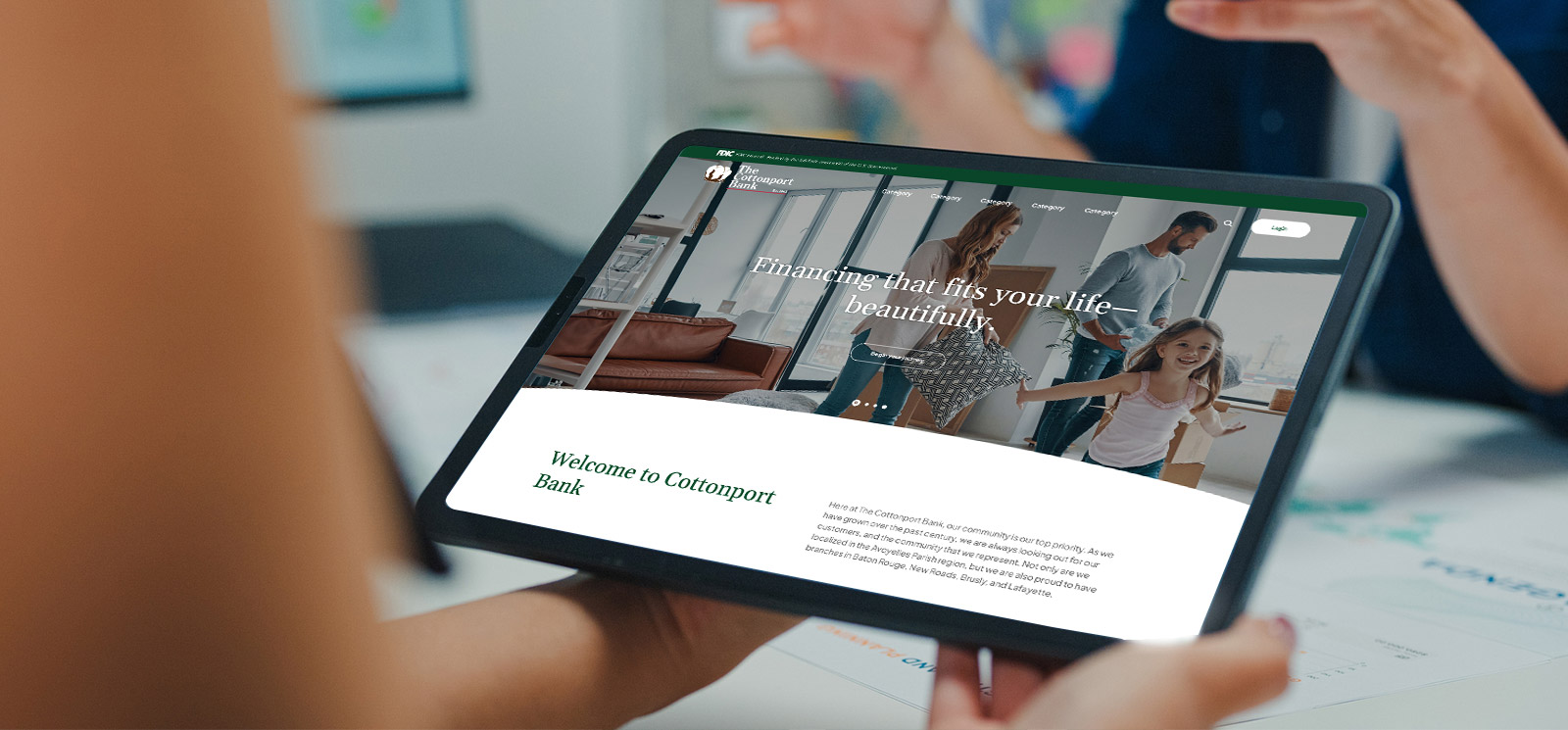 Person holding a tablet with new website.