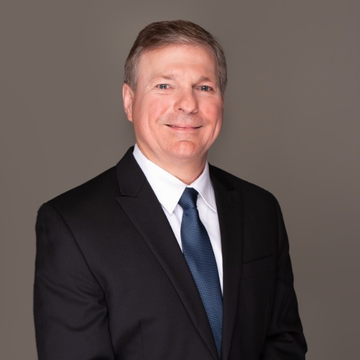 Blake in suit with navy tie.