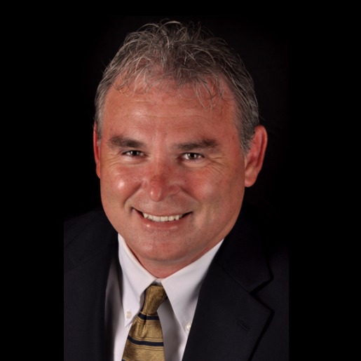 Todd in Black suit with gold tie.