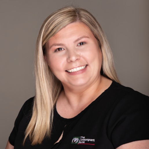 Clarissa in a black shirt with a tan background