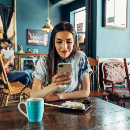 Person using their phone to pay a bill.