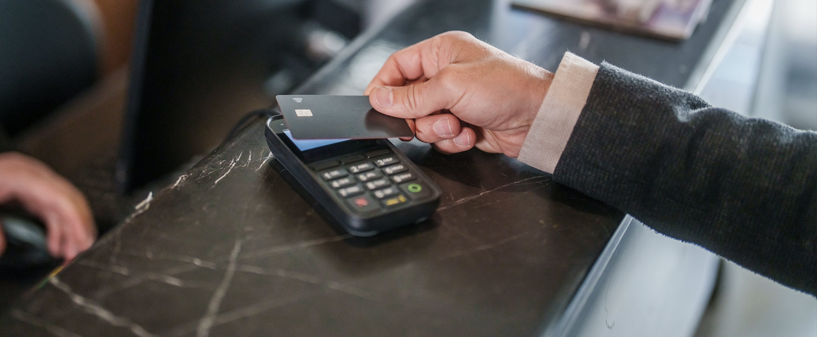 Business person paying with credit card.