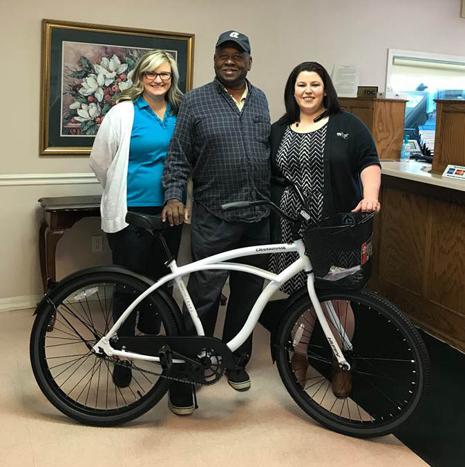 Three people with a bicycle