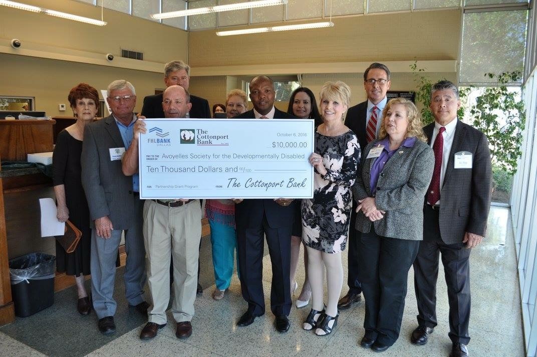 Group of people holding a gigantic check